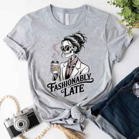 May include a short sleeve shirt featuring the phrase “Fashionably Late” in a stylish, modern font.