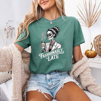 May include a short sleeve shirt featuring the phrase “Fashionably Late” in a stylish, modern font.