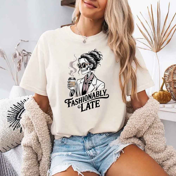 May include a short sleeve shirt featuring the phrase “Fashionably Late” in a stylish, modern font.