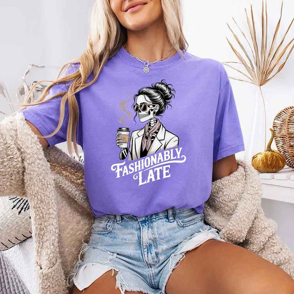 May include a short sleeve shirt featuring the phrase “Fashionably Late” in a stylish, modern font.