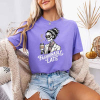 May include a short sleeve shirt featuring the phrase “Fashionably Late” in a stylish, modern font.