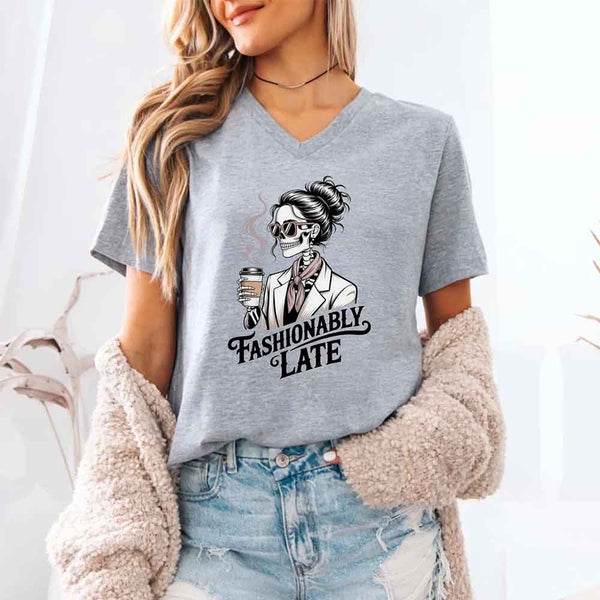 May include a short sleeve shirt featuring the phrase “Fashionably Late” in a stylish, modern font.