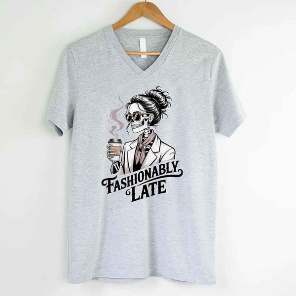 May include a short sleeve shirt featuring the phrase “Fashionably Late” in a stylish, modern font.
