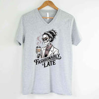 May include a short sleeve shirt featuring the phrase “Fashionably Late” in a stylish, modern font.