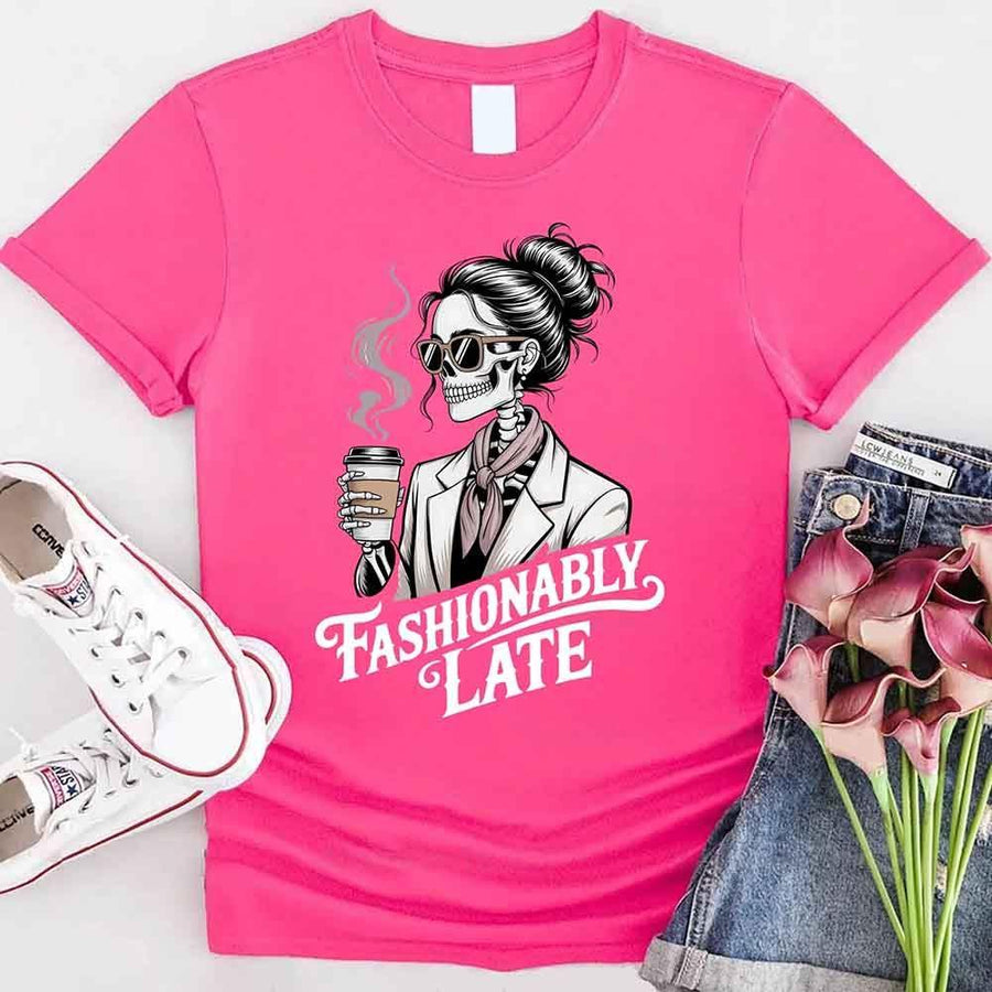 May include a short sleeve shirt featuring the phrase “Fashionably Late” in a stylish, modern font.