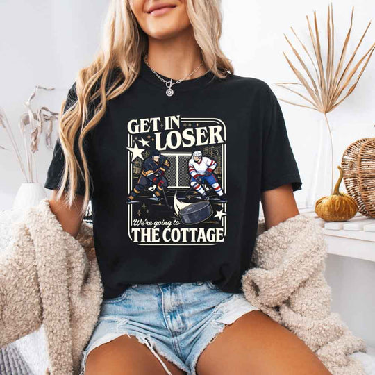 May include a person wearing a Black  Get in Loser We're Going to the Cottage Comfort Colors T-Shirt featuring sports romance graphic design and relaxed fit.