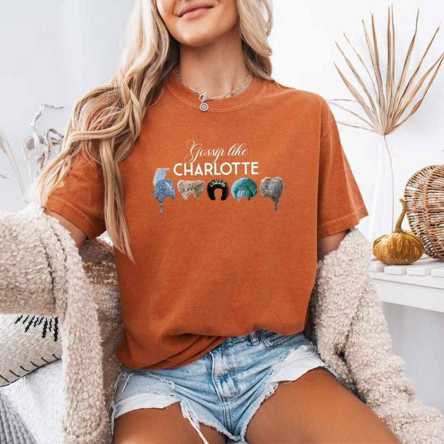 May include a person wearing a Yam Gossip Like Charlotte Wigs Comfort Colors T-Shirt featuring historical drama inspired graphic and relaxed fit.