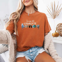 May include a person wearing a Yam Gossip Like Charlotte Wigs Comfort Colors T-Shirt featuring historical drama inspired graphic and relaxed fit.