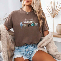 May include a person wearing a Espresso Gossip Like Charlotte Wigs Comfort Colors T-Shirt featuring historical drama inspired graphic and relaxed fit.