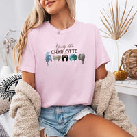 May include a person wearing a Blossom Gossip Like Charlotte Wigs Comfort Colors T-Shirt featuring historical drama inspired graphic and relaxed fit.