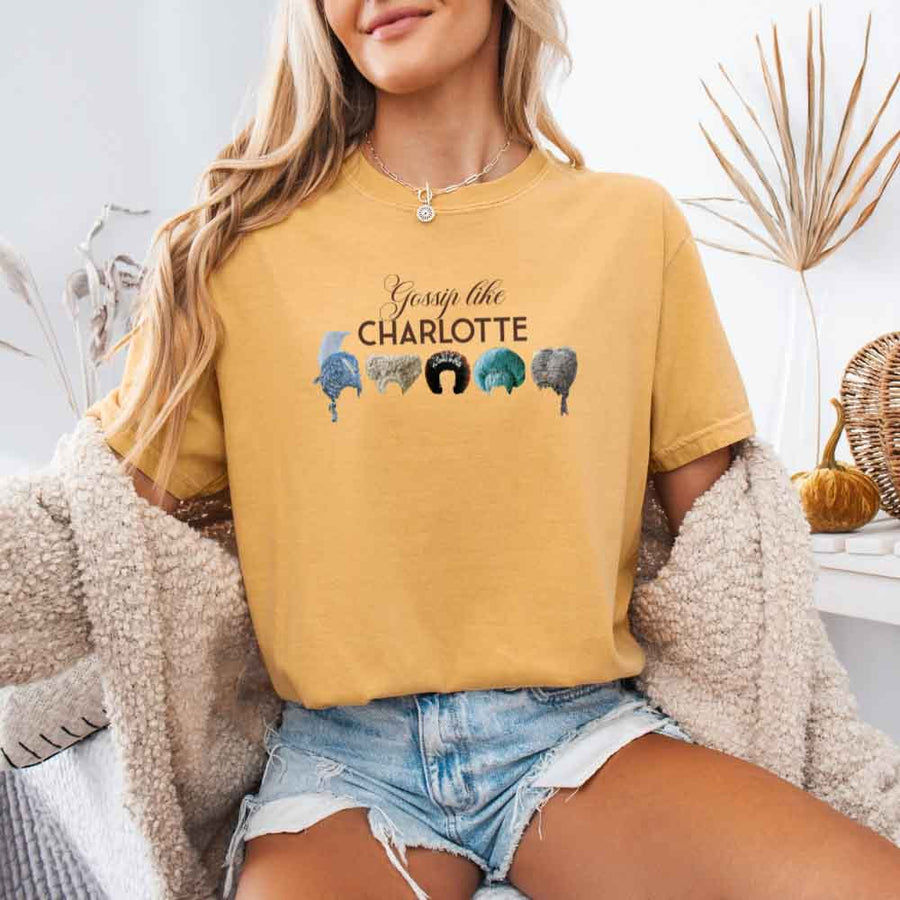 May include a person wearing a Mustard Gossip Like Charlotte Wigs Comfort Colors T-Shirt featuring historical drama inspired graphic and relaxed fit.