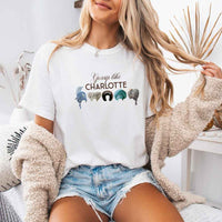 May include a person wearing a White Gossip Like Charlotte Wigs Comfort Colors T-Shirt featuring historical drama inspired graphic and relaxed fit.