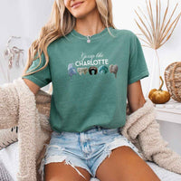 May include a person wearing a Light Green Gossip Like Charlotte Wigs Comfort Colors T-Shirt featuring historical drama inspired graphic and relaxed fit.
