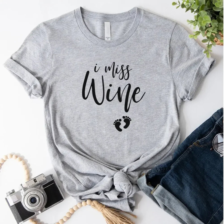 Grey custom t-shirt with 'I miss wine' print and baby footprints, styled with jeans.