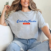 Person wearing a gray t-shirt with 'Celebrating Freedom Since 1776' text, sitting on a couch.