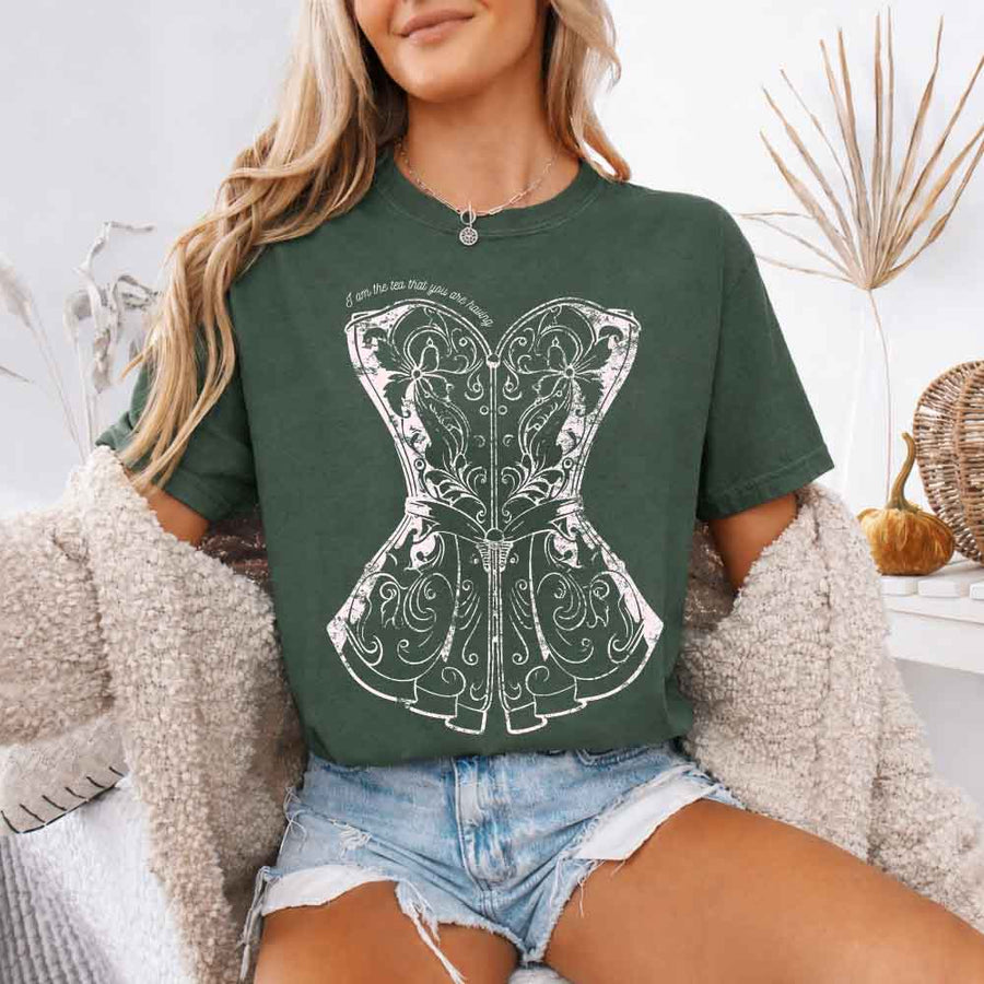 May include a person wearing a Moss I Am The Tea That You Are Having Comfort Colors T-Shirt featuring royal court inspired graphic and relaxed fit.