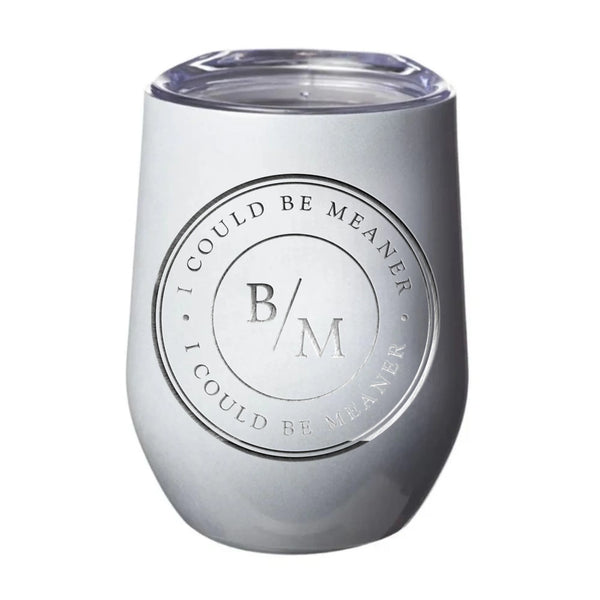 May include a wine tumbler displayed on a wooden surface, featuring a circular black design with the text “I COULD BE MEANER” repeated around the outer ring and the initials “B/M” centered inside. 