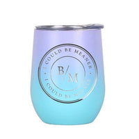 May include a wine tumbler displayed on a wooden surface, featuring a circular black design with the text “I COULD BE MEANER” repeated around the outer ring and the initials “B/M” centered inside. 