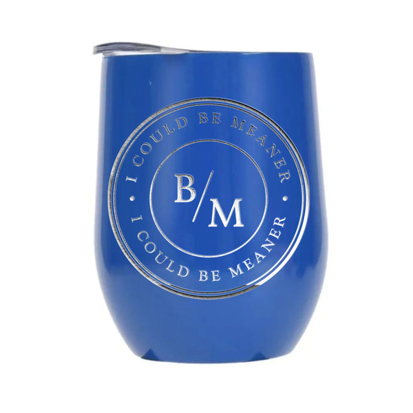 May include a wine tumbler displayed on a wooden surface, featuring a circular black design with the text “I COULD BE MEANER” repeated around the outer ring and the initials “B/M” centered inside. 