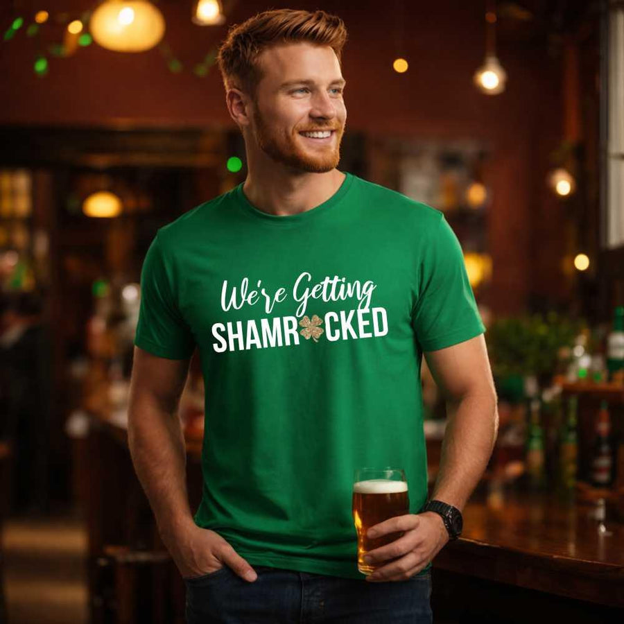 May include a couple wearing matching St. Patrick’s Day engagement t-shirts with the phrase “I Got The Rock”.