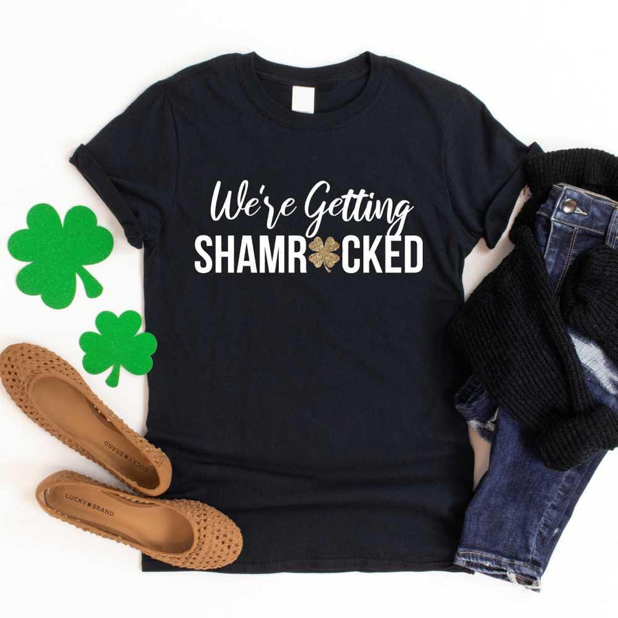 May include a couple wearing matching St. Patrick’s Day engagement t-shirts with the phrase “I Got The Rock”.
