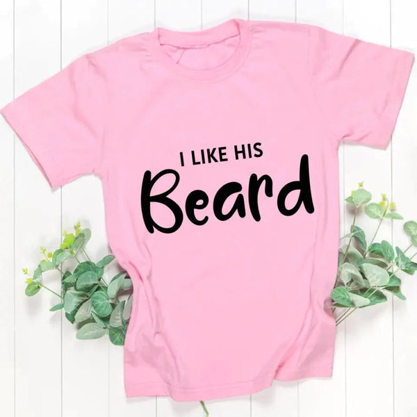 May include a pair of unisex couple t-shirts reading “I Like His Beard” and “I Like Her Butt,” displayed side by side in black and white cotton.