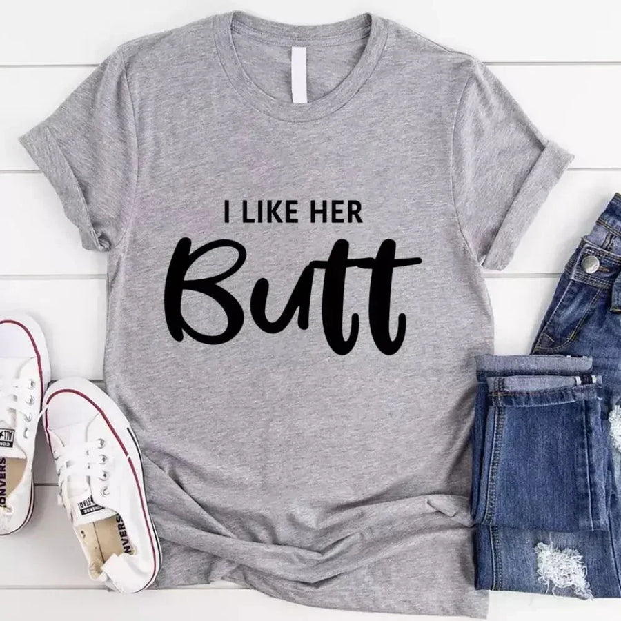 May include a pair of unisex couple t-shirts reading “I Like His Beard” and “I Like Her Butt,” displayed side by side in black and white cotton.