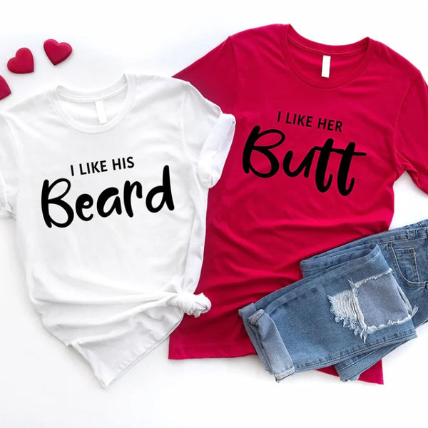 May include a pair of unisex couple t-shirts reading “I Like His Beard” and “I Like Her Butt,” displayed side by side in black and white cotton.