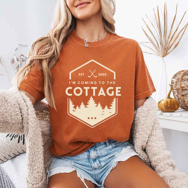 May include a person wearing a Yam I’m Coming to the Cottage T-Shirt featuring rivalry inspired graphic design and relaxed fit.