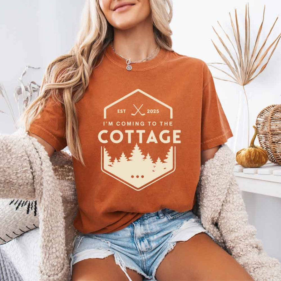 May include a person wearing a Yam I’m Coming to the Cottage T-Shirt featuring rivalry inspired graphic design and relaxed fit.