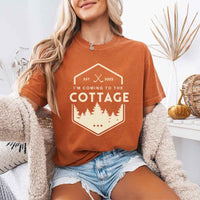 May include a person wearing a Yam I’m Coming to the Cottage T-Shirt featuring rivalry inspired graphic design and relaxed fit.