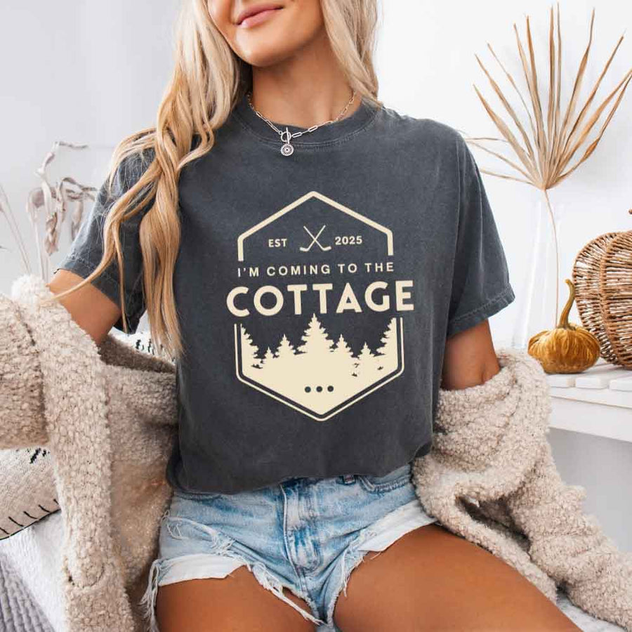 May include a person wearing a Pepper I’m Coming to the Cottage T-Shirt featuring rivalry inspired graphic design and relaxed fit.