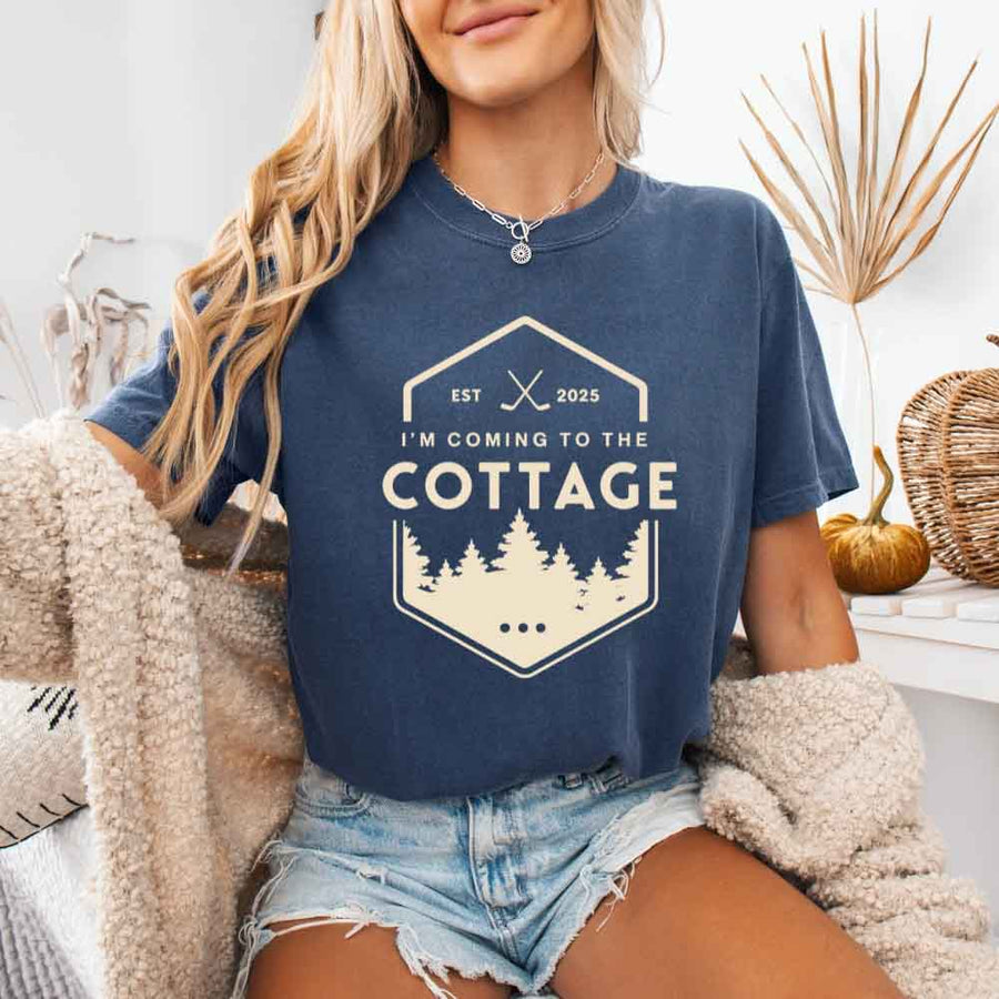 May include a person wearing a Denim I’m Coming to the Cottage T-Shirt featuring rivalry inspired graphic design and relaxed fit.