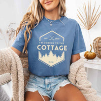 May include a person wearing a Blue Jean I’m Coming to the Cottage T-Shirt featuring rivalry inspired graphic design and relaxed fit.