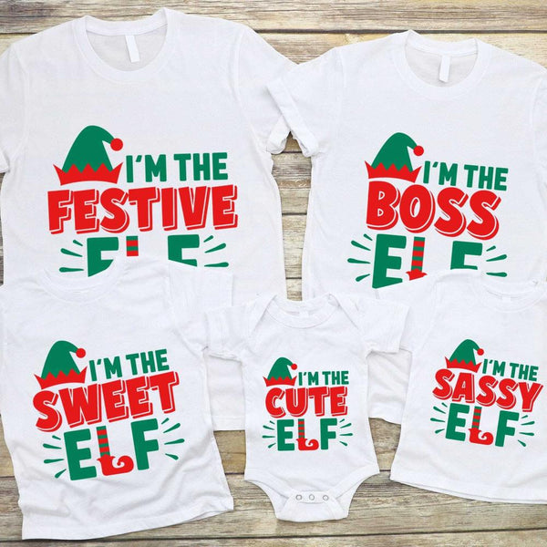 May include a youth Christmas tee with an I’m The Boss Elf design printed on the front, shown on a plain background.
