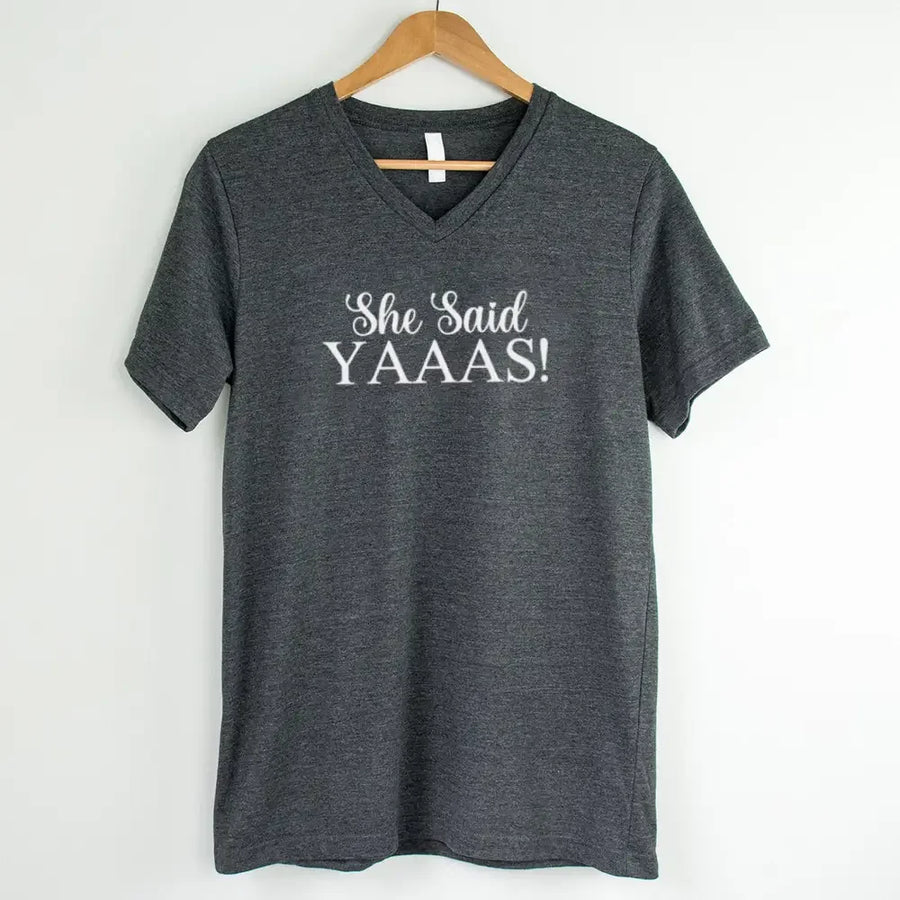 Gray t-shirt with 'She Said YAAAS!' text on a hanger against a white background