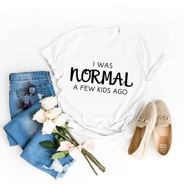 May include a women’s t-shirt with the phrase “I Was Normal a Few Kids Ago,” displayed flat or worn by a mom, highlighting a humorous motherhood theme.