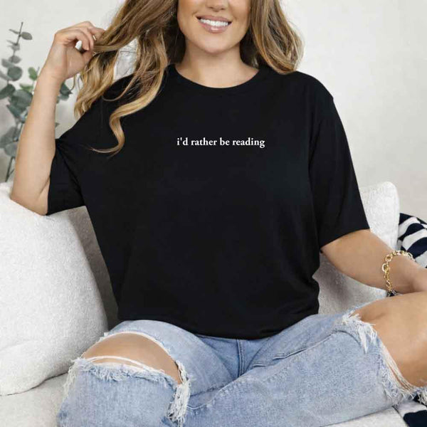 May include a person wearing a Black I'd Rather Be Reading T-Shirt featuring trendy book lover graphic and relaxed fit.

