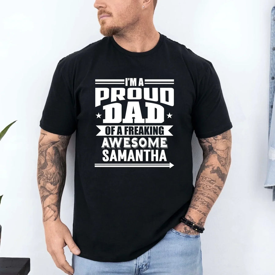 May include a father and child wearing matching t-shirts reading “I’m A Proud Dad” and “Me”