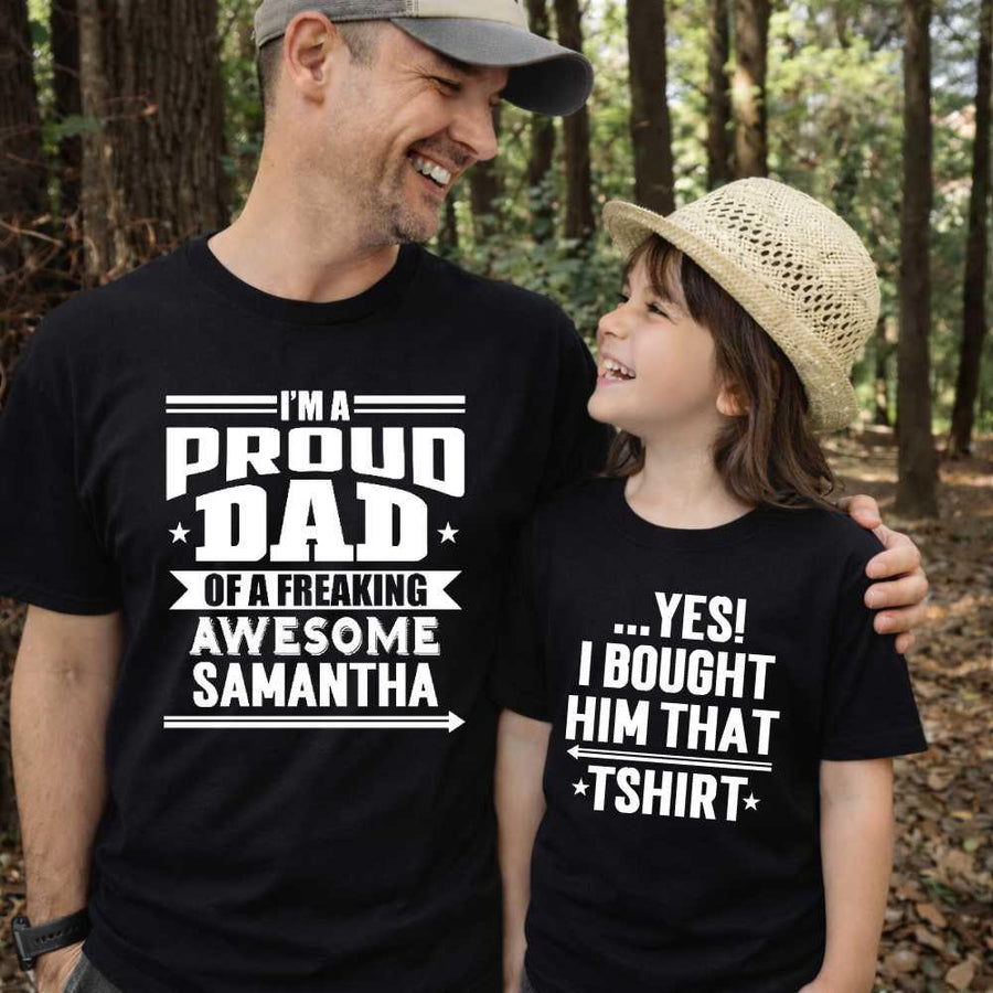 May include a father and child wearing matching t-shirts reading “I’m A Proud Dad” and “Me”