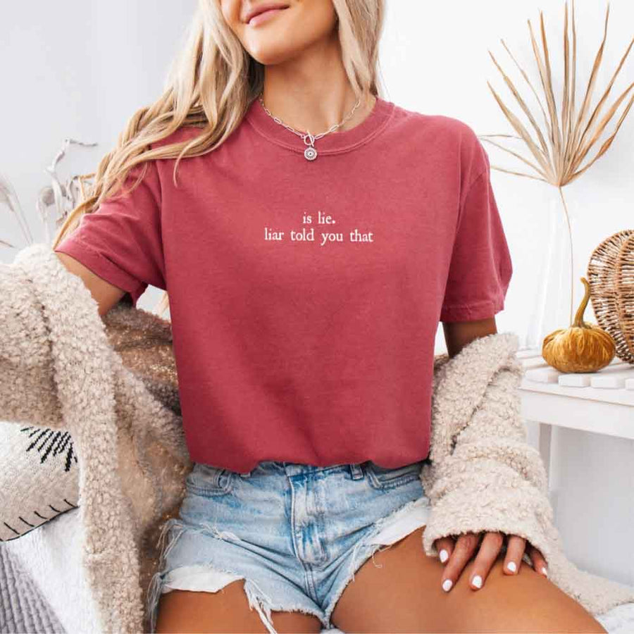 May include a person wearing a Crimson Is Lie Liar Told You That Comfort Colors T-Shirt featuring rivalry inspired graphic and relaxed fit.