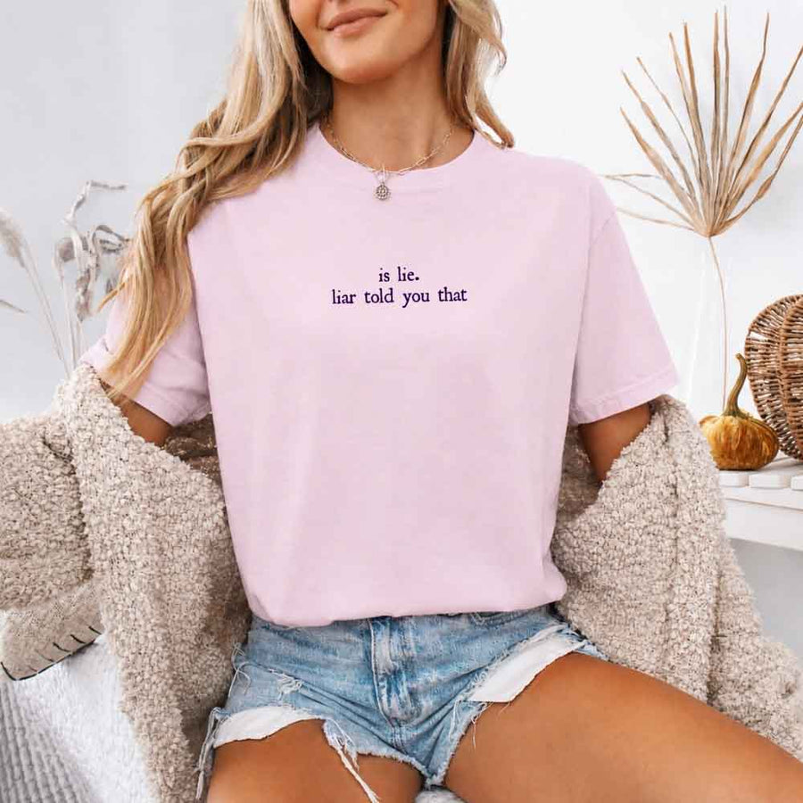 May include a person wearing a Blossom Is Lie Liar Told You That Comfort Colors T-Shirt featuring rivalry inspired graphic and relaxed fit.