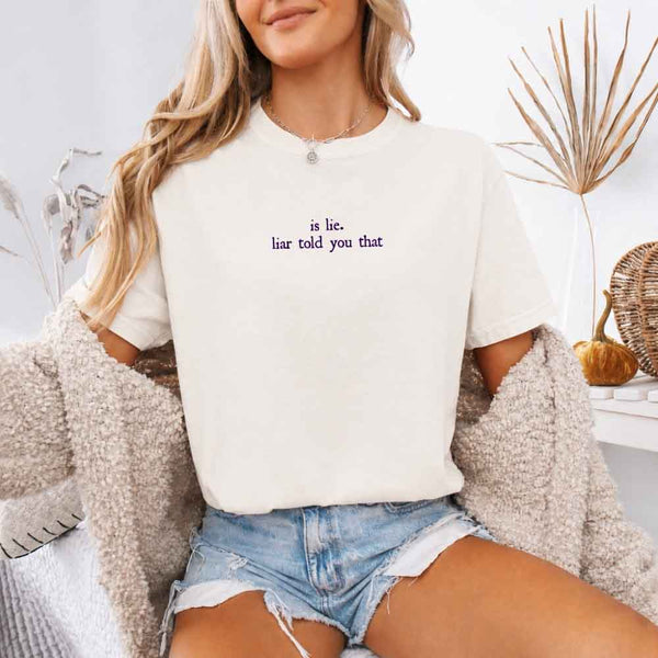 May include a person wearing a Ivory Is Lie Liar Told You That Comfort Colors T-Shirt featuring rivalry inspired graphic and relaxed fit.