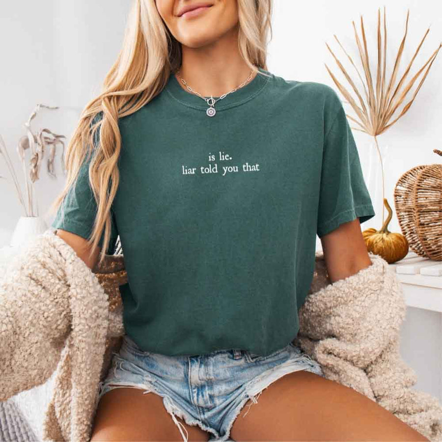 May include a person wearing a Blue Spruce Is Lie Liar Told You That Comfort Colors T-Shirt featuring rivalry inspired graphic and relaxed fit.