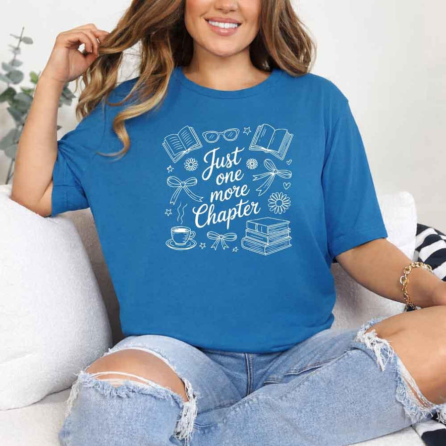May include a person wearing a Sapphire Just One More Chapter T-Shirt featuring trendy book lover graphic and relaxed fit.