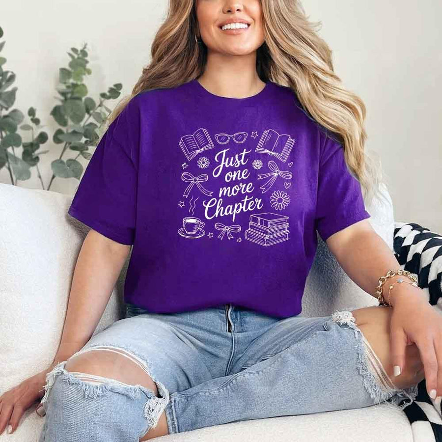 May include a person wearing a Purple Just One More Chapter T-Shirt featuring trendy book lover graphic and relaxed fit.