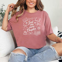 May include a person wearing a Mauve Just One More Chapter T-Shirt featuring trendy book lover graphic and relaxed fit.

