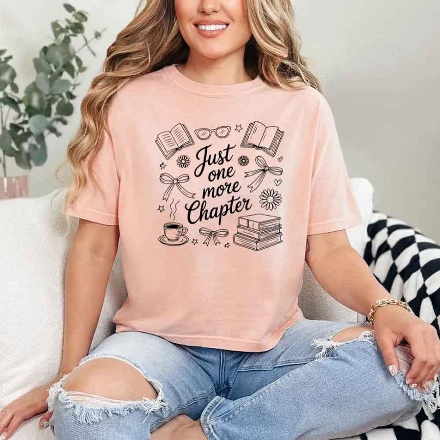 May include a person wearing a Peach Just One More Chapter T-Shirt featuring trendy book lover graphic and relaxed fit.