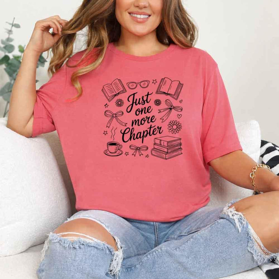 May include a person wearing a Coral Silk Just One More Chapter T-Shirt featuring trendy book lover graphic and relaxed fit.