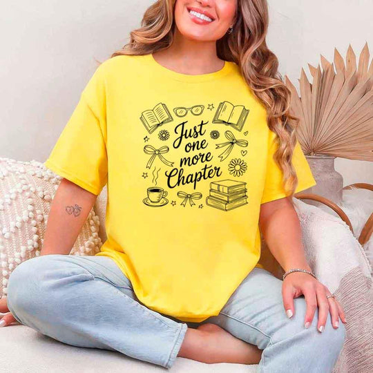 May include a person wearing a Daisy Just One More Chapter T-Shirt featuring trendy book lover graphic and relaxed fit.